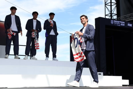 Christian Pulisic poses with his jersey during the United States World Cup roster reveal.
