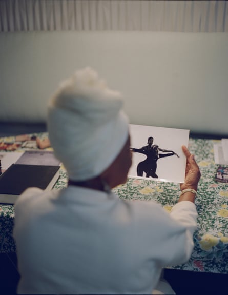 a woman holds an old photo