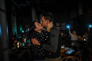A couple kiss in a bar during a power cut in Kyiv, Ukraine