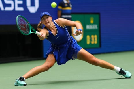 Mirra Andreeva stretches for a forehand.