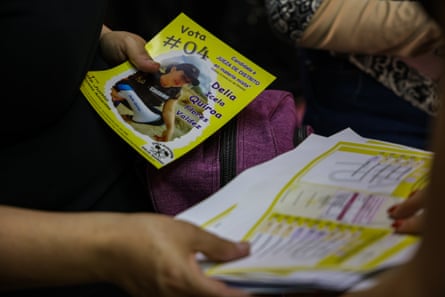 close up of a pair of hands handing out pamphlets