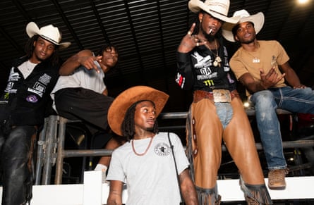 Members of the Outlaws Most Wanted bronc riding team gather behind the arena
