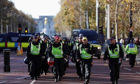Riot police officers walk along the Mall during the pro-Palestine march in London