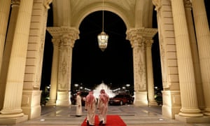 Men walk out of the entrance of the Ritz-Carlton hotel in Riyadh