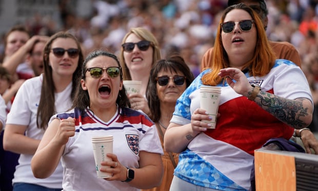 Supporters react to the action on the big screen at Trafalgar Square as they watch the Euro 2022 final.