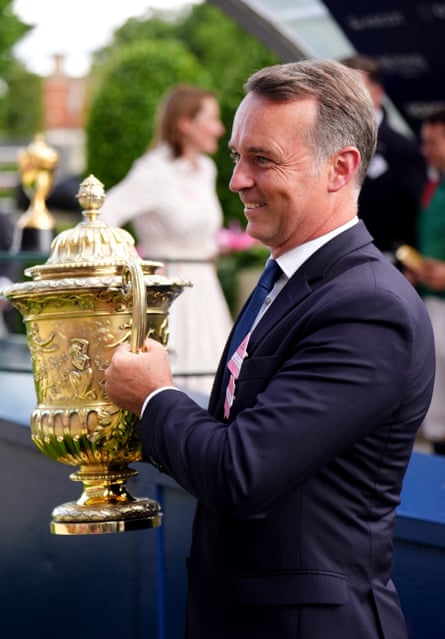 Trainer Francis-Henri Graffard shows off the trophy after Calandagan won the King George VI And Queen Elizabeth Stakes at Ascot.
