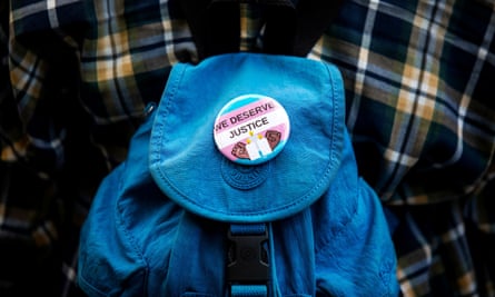 A ‘We Deserve Justice’ button is seen as people New York protest the killings of three trans women – Muhlaysia Booker, Claire Legato and Michelle Washington – in 2019.