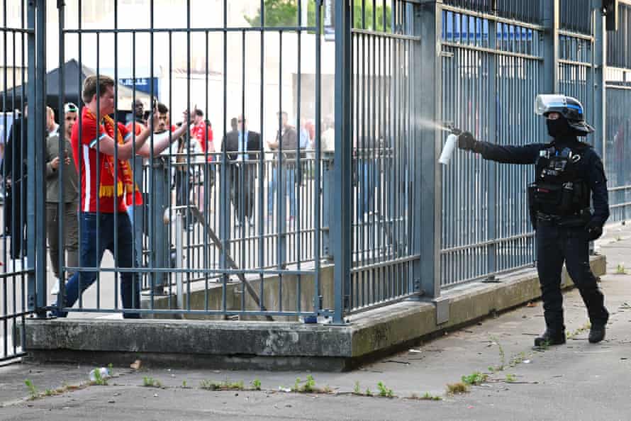 Police spray teargas at Liverpool fans outside the stadium as they queue for the game.