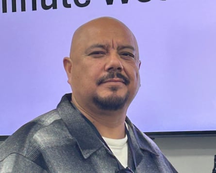 A middle-aged man, bald and with a goatee.