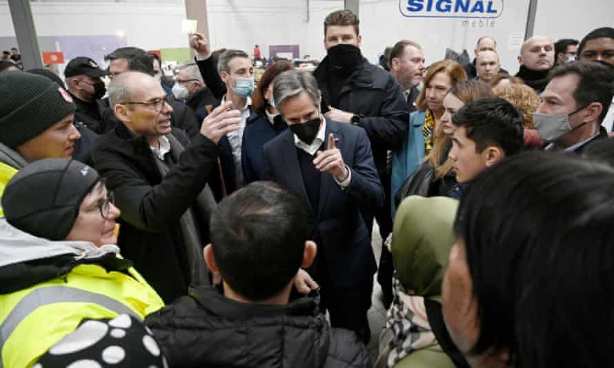 US secretary of state Antony Blinken (in face mask) meets with refugees.