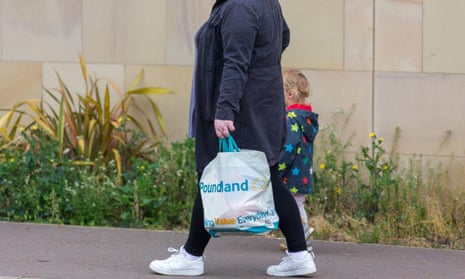 A mother and child walking with a Poundland shopping bag in Halifax, West Yorkshire