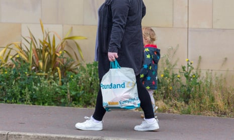 A mother and child walking with a Poundland shopping bag in Halifax, West Yorkshire.