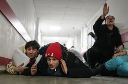 People lie on the floor of a hospital during shelling by Russian forces on 4 March 2022, in a still image from the film 20 days in Mariupol.
