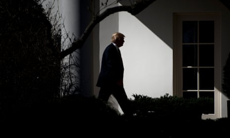 Donald Trump walks alone at the White House.