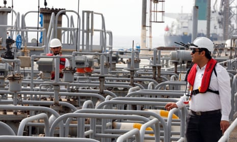 Iranian technicians work at the Kharg oil terminal at the Kharg Island, southern Iran. The US government has announced it will reimpose sanctions that had been waived under the Iran nuclear deal.
