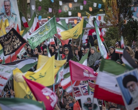 Iranian mourners wave flags during a religious rally in Tehran last weekend condemning Israeli attacks on Iran