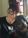 She poses for a selfie with her fluffy black dog
