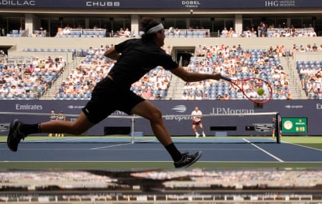 Taylor Fritz races for a forehand.