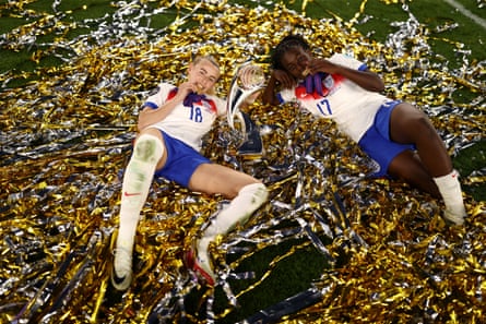 Chloe Kelly and Michelle Agyemang of England pose for a photo amid the ticker tape during the on-pitch celebrations.
