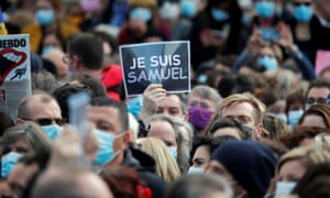 Protesters at Place de la République in Paris pay tribute to Samuel Paty.