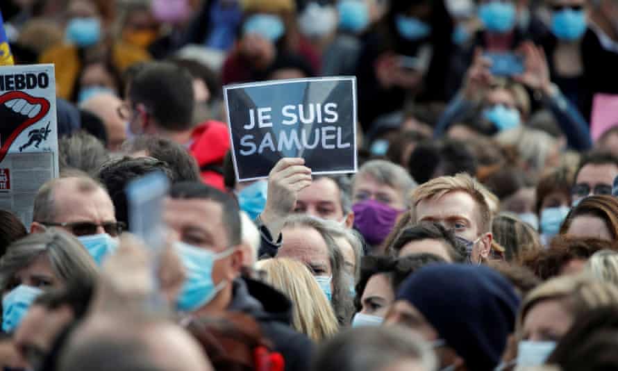 Protesters at Place de la République in Paris pay tribute to Samuel Paty.