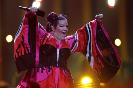 Israel’s Netta, wearing a pink dress with huge sleeves, performs Toy at Eurovision in Lisbon in 2018.