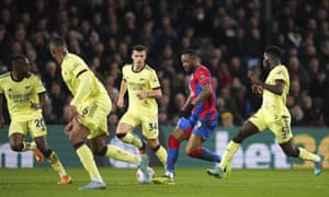 Jordan Ayew of Crystal Palace surrounded by Arsenal defenders as he surges forewards.