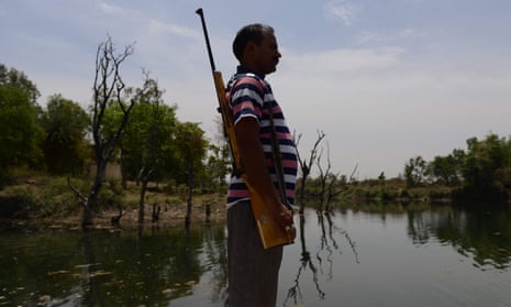 An armed guard at a reservoir in Tikamgarh in the central Indian state of Madhya Pradesh.