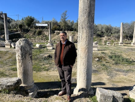 Mahmud Azem standing next to archaeological ruins
