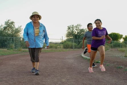 Gloria Hosteen gets some exercise with grandson Logan and granddaughter Destenie, at the track of the former Shiprock High School.