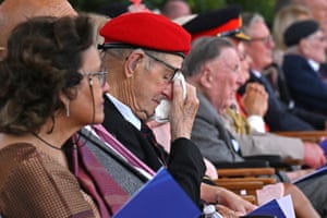 A veteran wipes a tear during the service