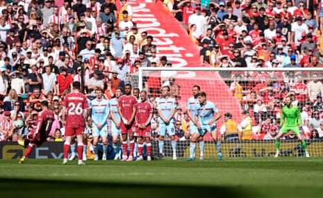 Mohamed Salah pings a free-kick off the post for Liverpool.