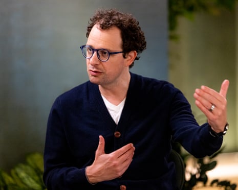 Man gestures sitting in chair