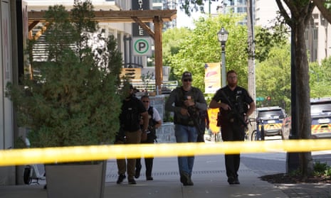 Police officers at the scene of the shooting in midtown Atlanta, where one person died and four were injured.