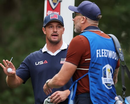 Ian Finnis (right), caddie for Tommy Fleetwood, interjects after heated moments involving Bryson DeChambeau during Saturday’s fourballs