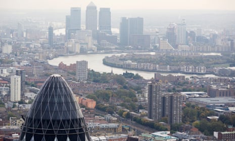 Aerial view of the City of London, with the bank buildings of Canary Wharf in the background.