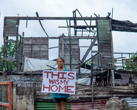 ‘this was my home’ in front of the ruins of a house
