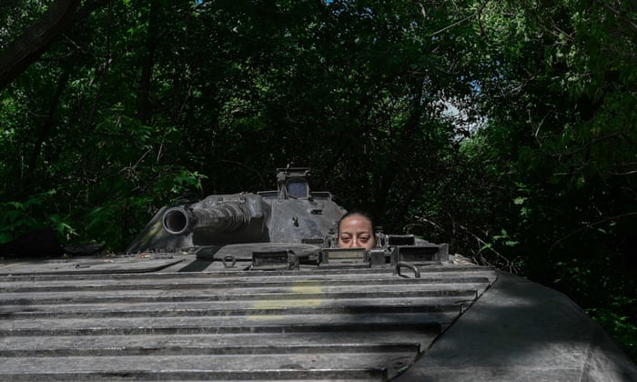 Karina, a former textile worker of Tajik origin, sits in a military vehicle during an interview with AFP in Donbas region, eastern Ukraine, on 26 July.