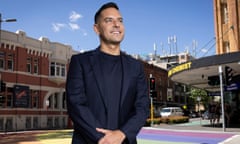 NSW independent MP Alex Greenwich standing in front of rainbow pride crossing in Sydney