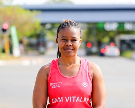 A woman in a coral pink running vest