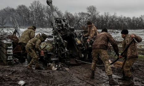 Ukrainian service members fire a shell from an M777 Howitzer at a front line in Donetsk Region.
