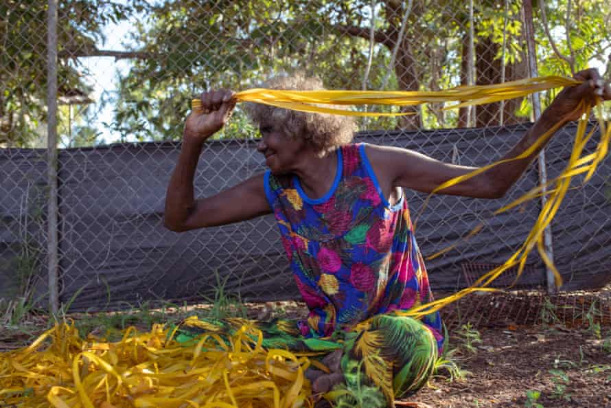 'Bringing the sun in': Bula'Bula's hardworking weavers dig color out of the red soil | native art Evonne dries off the freshly painted pandanus