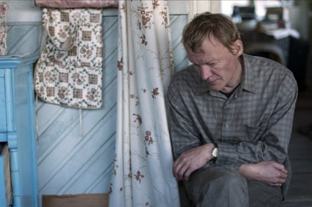 Serebryakov sits leaning forward, looking unhappy and seemingly gazing at the floor, his arms crossed on his lap