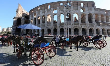 Horse-drawn carriages in front of Rome’s Colosseum