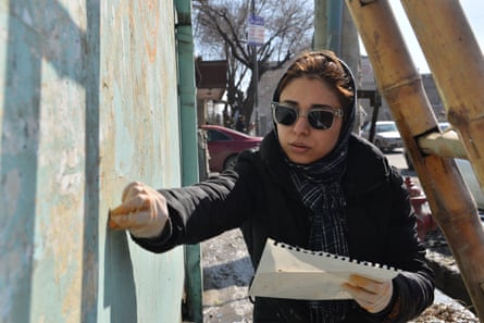Shamsia Hassani works on a mural in Serahi Alauddin, Kabul.
