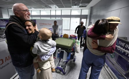 People are greeted by relieved family members after arriving back in Germany on a flight from Dubai.