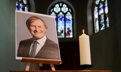 A candle and a portrait of British MP David Amess in the church of St Michael's and all Angels, in Leigh-on-Sea.