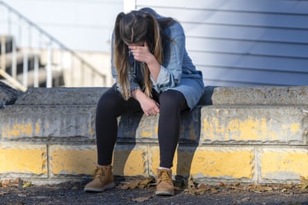 University of Idaho student Alaina Tempelis prays on 17 November 2022, in Moscow, Idaho, outside of the home where four fellow students were recently murdered.