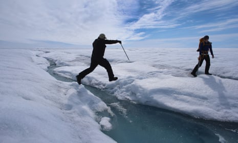 A scientist leaps over water during a trip to the Greenland ice sheet, which saw melting over more than 50% of its surface last year.