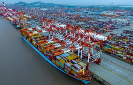 Aerial view of large container vessels and shipping containers at Yangshan Deep-Water Port in Shanghai, China.